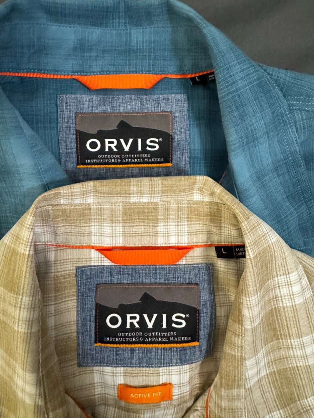 2 Orvis plaid short sleeve, button up shirts.